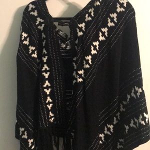 Hooded black and white poncho with clasp